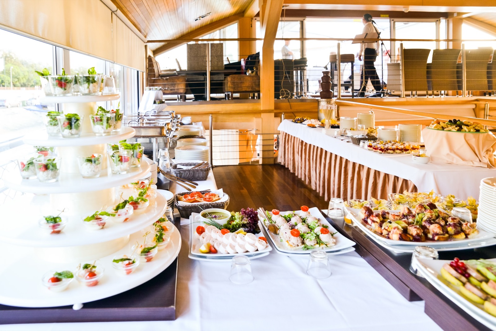 Cold buffet laid out on board, with the dessert table behind