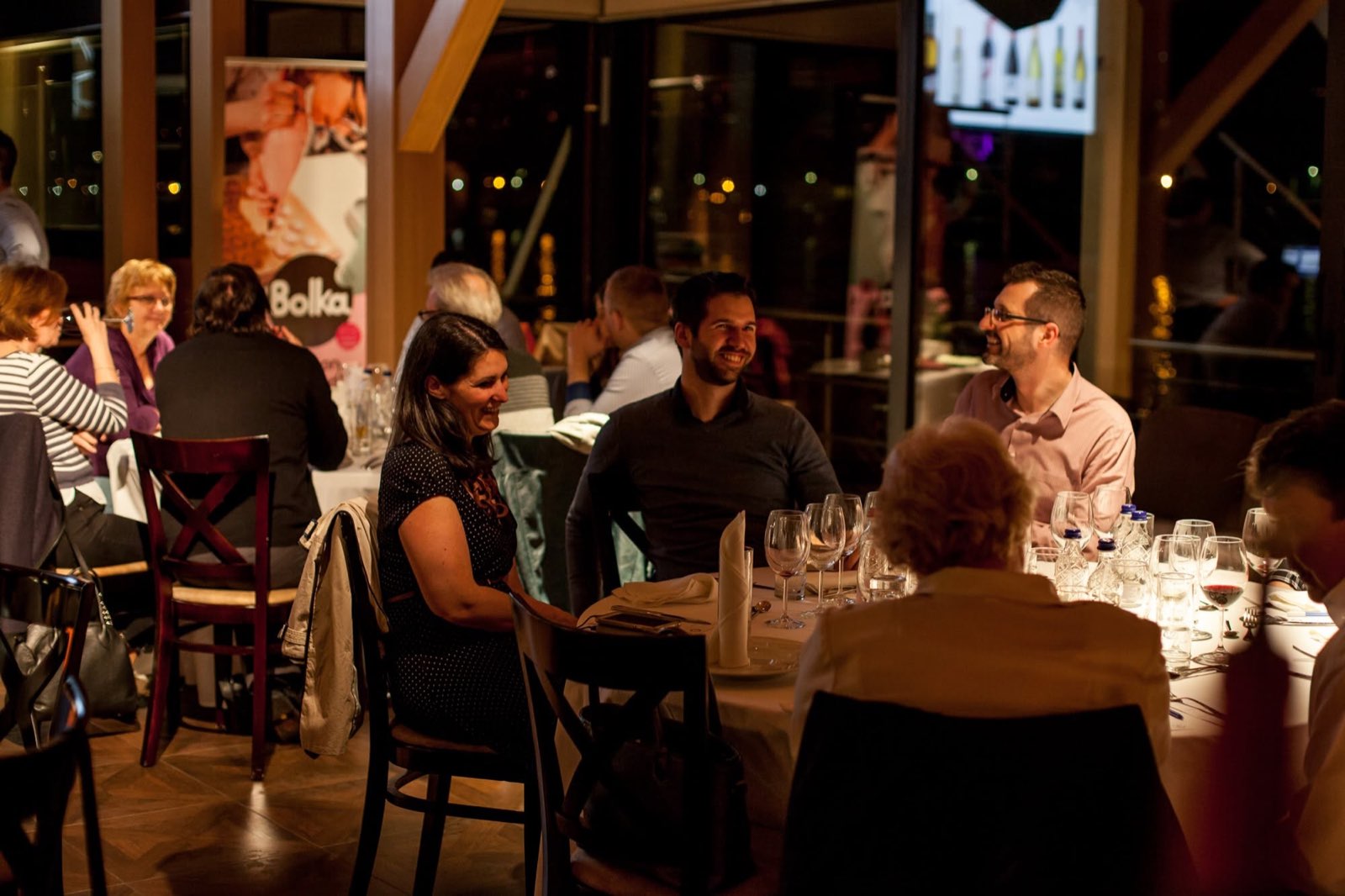 Guests at laid tables in the evening